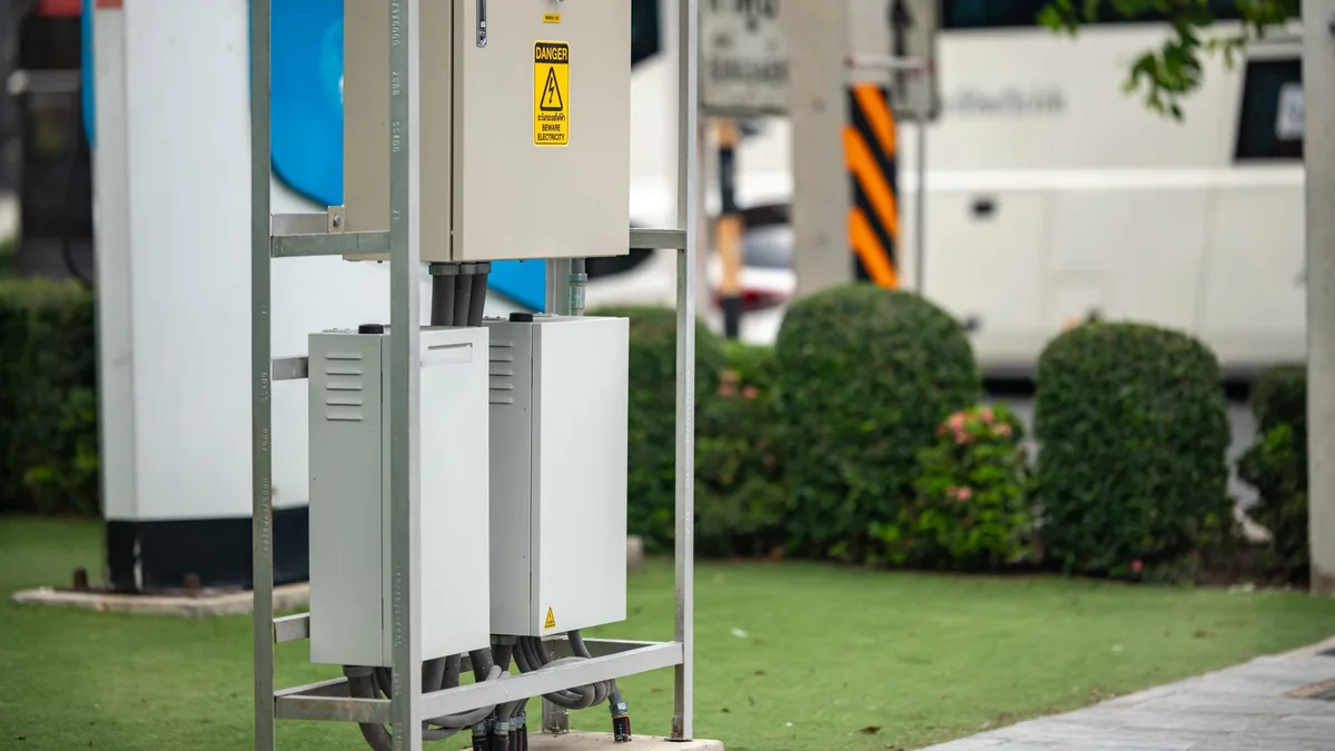 Modern electric vehicle charging station with greenery in an urban setting.