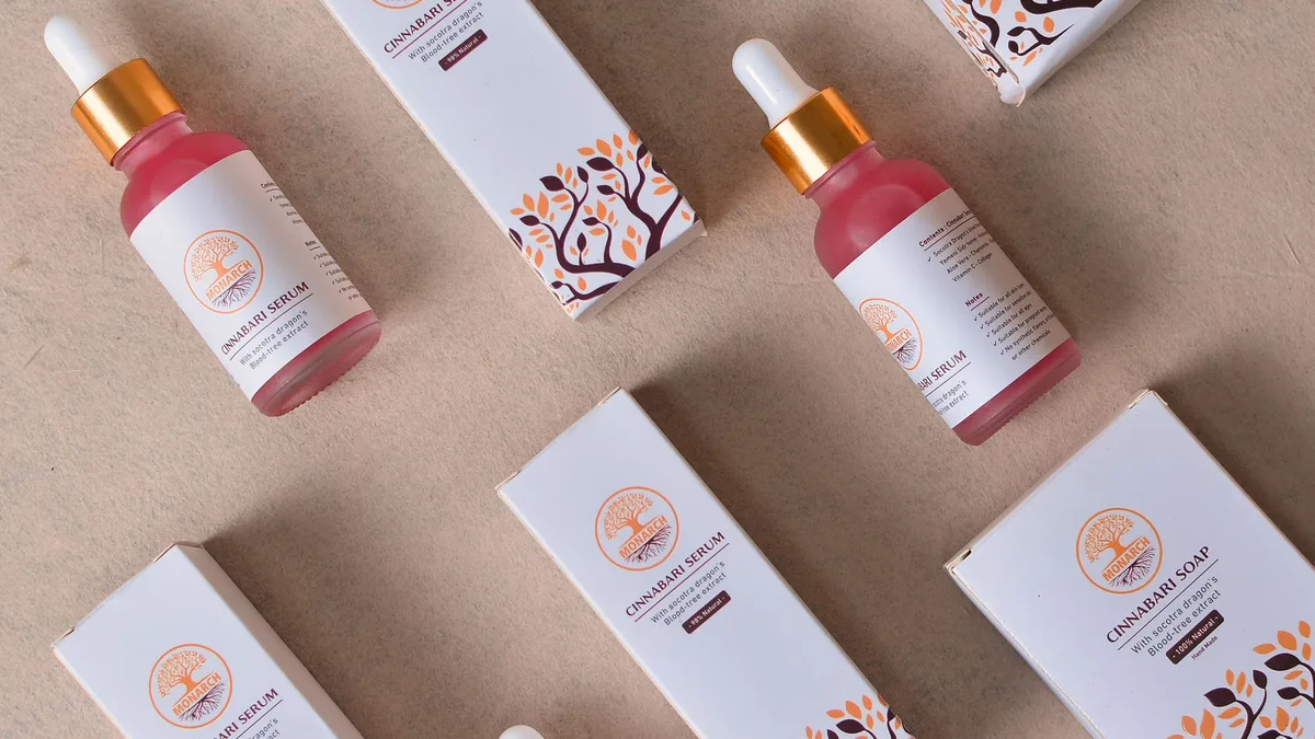 Flat lay of cosmetic serum bottles and boxes for beauty and skincare.
