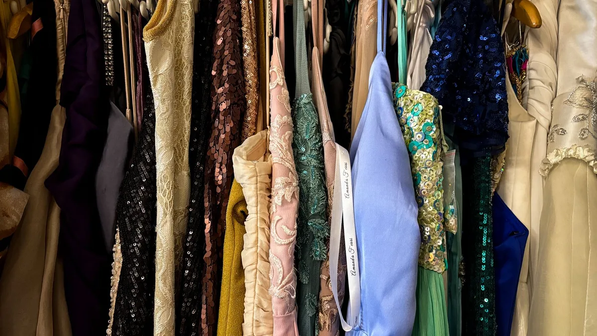 A vibrant collection of vintage dresses hanging on racks, showcasing diverse styles and fabrics.